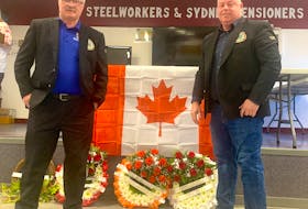 Brian Lahey, left, and Joe Wilson of the Carpenters Union Local 1588 lay a wreath on Sunday during the Cape Breton District Labour Council’s National Day of Mourning ceremony at the Steelworkers’ and Pensioners Hall in Sydney. The National Day of Mourning began in 1991 to honour the Canadians who were killed, injured or became ill  because of workplace incidents. In 2023, 18 Nova Scotians died at work or because of their work, including seven acute traumatic injuries and 11 chronic injury fatalities. CHRIS CONNORS/CAPE BRETON POST
