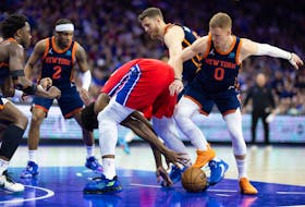 Apr 28, 2024; Philadelphia, Pennsylvania, USA; Philadelphia 76ers center Joel Embiid (21) and New York Knicks guard Donte DiVincenzo (0) battle for a loose ball during the first half of game four of the first round in the 2024 NBA playoffs at Wells Fargo Center. Mandatory Credit: Bill Streicher-USA TODAY Sports