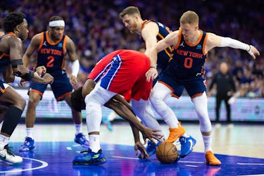 Apr 28, 2024; Philadelphia, Pennsylvania, USA; Philadelphia 76ers center Joel Embiid (21) and New York Knicks guard Donte DiVincenzo (0) battle for a loose ball during the first half of game four of the first round in the 2024 NBA playoffs at Wells Fargo Center. Mandatory Credit: Bill Streicher-USA TODAY Sports