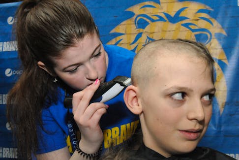 The St. John’s branch of the Young Adult Cancer Canada (YACC) held their 19th. annual and spring Shave For The Brave at the Avalon Mall on Saturday, April 27, 2024 in support of young adults living with, through, and beyond cancer. It’s their largest fundraiser which runs in schools, offices, public venues and communities from coast to coast. Among those young youth taking to the clippers of Keyin College hair dressing student Jenna Hayes on Saturday was Mount Pearl resident Dutch Stratton. A Grade 6 student at St. Peter’s Elementary School in his hometown, the 11-year-old let his hair grow for a few years awaiting the shave in memory of his school friends Sophia Crowley and Clarke Howell, also a hockey teammate of his, who both lost their childhood battle with cancer a few years back. Sophia passed away on February 10, 2022, age 10, while Clark passed away on September 4, 2021, age 12. In order to participate, shavers must agree to have their heads shaved with no guard, or donate at least 10 inches of hair and are also responsible for raising or donating at least $25 in order to receive an official Shave for the Brave iconic yellow toque.
-Photo by Joe Gibbons/The Telegram