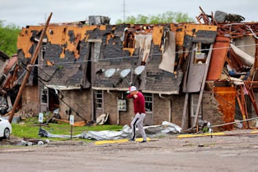 A man walks past a damaged building after it was hit by a tornado the night before in Sulphur, Oklahoma, U.S. April 28, 2024.   Bryan Terry/The Oklahoman/USA Today Network via REUTERS