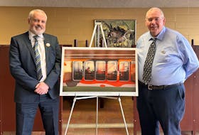 Simon Lloyd, left, special collections librarian, and Donald Moses, university librarian, stand next to a photo that displays the upcoming changes to UPEI's Robertson Library. During a news conference held April 26 to announce a fundraising campaign, Moses told SaltWire plans are underway for the library's first major renovation in 50 years. - Vivian Ulinwa/SaltWire