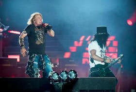 Axl Rose (left), lead singer of rock band Guns N' Roses, performs with Slash at Parken Stadium in Copenhagen, Denmark, June 27, 2017.