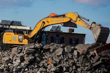 A Caterpillar (Cat) Excavator is seen working at a construction site near the New York Harbor in Brooklyn, New York, U.S., March 4, 2021. 