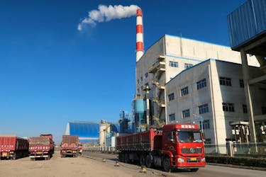 A truck passes by a chemical factory near the Jinjie Industrial Park in Shenmu, Shaanxi province, China November 20, 2023.