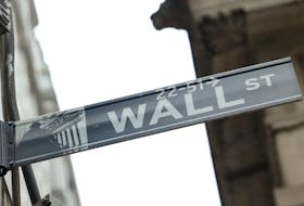 A street sign marks Wall Street outside the New York Stock Exchange (NYSE) in New York City, where markets roiled after Russia continues to attack Ukraine, in New York, U.S., February 24, 2022.  