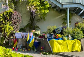 Flowers and candles are placed at the scene, as residents mourn the death of two Ukrainian soldiers in the small southern town of Murnau, Germany, April 29, 2024. The two soldiers were on rehabilitation in Germany and allegedly stabbed on Saturday, April 27, 2024 by a Russian in front of a shopping centre, according to the Ukrainian Foreign Ministry. The suspect was arrested by German police shortly after the stabbing.   