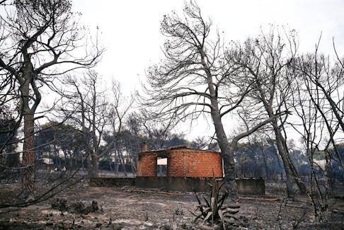 A burned house is seen following a wildfire at the village of Mati, near Athens, Greece July 24, 2018.