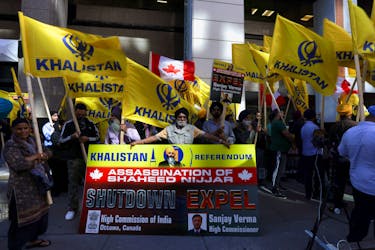 A group of protesters hold yellow flags with the word Khalistan, as well as a banner with the picture of Sikh separatist leader Hardeep Singh, during a protest outside India's consulate, a week after Canada's Prime Minister Justin Trudeau raised the prospect of New Delhi's involvement in the murder of Sikh separatist leader Hardeep Singh Nijjar in British Columbia, in Toronto, Ontario, Canada September 25, 2023.