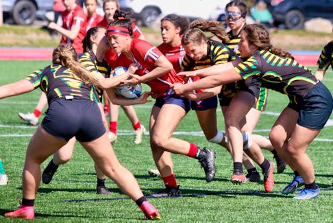 Frances Aceron powered up the pitch during the Highlanders Rugby Classic championship final against the Three Oaks Axewomen.