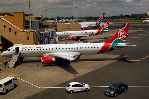 Kenya Airways planes are seen through a window at the Jomo Kenyatta international airport in Nairobi, Kenya August 1, 2020.