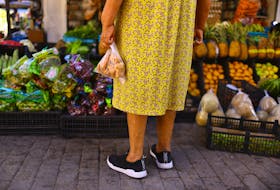 Martha Meza stands in front of a stall in an outdoor market dedicated to the sale of fruits and vegetables, in downtown of Ciudad Juarez, Mexico July 27, 2023.