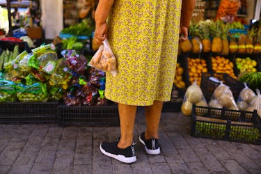 Martha Meza stands in front of a stall in an outdoor market dedicated to the sale of fruits and vegetables, in downtown of Ciudad Juarez, Mexico July 27, 2023.