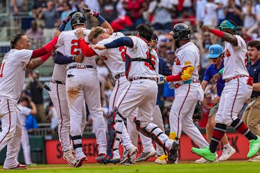 Apr 26, 2024; Cumberland, Georgia, USA; Atlanta Braves third baseman Austin Riley (27) reacts with teammates after hitting the game winning single against the Cleveland Guardians during the tenth inning at Truist Park. Mandatory Credit: Dale Zanine-USA TODAY Sports