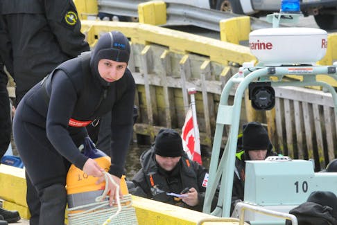 Navy diver Second-Class Sailor (S2) Nour Houdeib of the HMCS Scotian naval reserve unit at CFB Halifax prepares a personnel buoy marker to take on board a fast-rescue craft to head across the tickle to Lance Cove on Bell Island during under/on water diving exercises on Saturday morning, April 27. Joe Gibbons • The Telegram