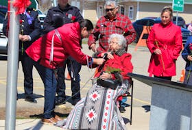 Elder Viola Christmas crosses herself as she starts the opening prayer at the ceremony held on Red Dress Day, also known as National Day of Awareness for Missing and Murdered Indigenous Women and Girls and Two-Spirit people, held in Membertou last year. It took place at the Red Dress Commemorative Park, located on the front lawn of the Cape Breton Regional Police station in Membertou, and it was the first event held at the park since it opened last year. NICOLE SULLIVAN/CAPE BRETON POST