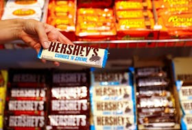 An employee shows a Hershey's chocolate bar made in USA in the "American lifestyle" store in Berlin, Germany, August 13, 2018.