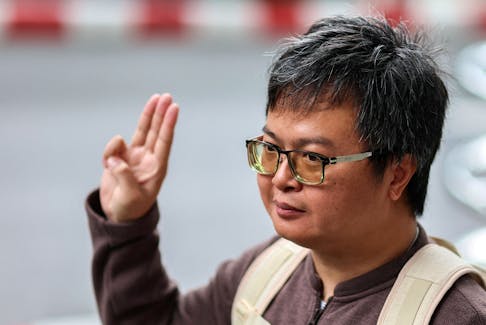 Arnon Nampa, a prominent activist and former human rights lawyer, flashes a three finger salute as he arrives ahead of a Thai criminal court's verdict in a case of allegedly having insulted the monarchy, at the criminal court in Bangkok, Thailand, September 26, 2023.