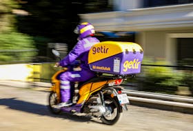 An employee of Turkish fast grocery-delivery company Getir rides to deliver an online grocery delivery in Istanbul, Turkey November 12, 2021.