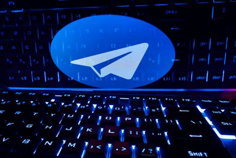 A keyboard is placed in front of a displayed Telegram logo in this illustration taken February 21, 2023.