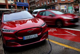 A Ford Mustang Mach-e electric vehicle is seen plugged into a charging station in Bilbao, northern Spain, November 10, 2023.