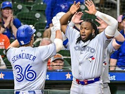 Davis Schneider (36) of the Toronto Blue Jays celebrates hitting a two-run home run with Vladimir Guerrero Jr. (27) in the ninth inning for a 2-1 lead against the Houston Astros at Minute Maid Park on Tuesday, April 2, 2024, in Houston. 