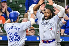 Davis Schneider (36) of the Toronto Blue Jays celebrates hitting a two-run home run with Vladimir Guerrero Jr. (27) in the ninth inning for a 2-1 lead against the Houston Astros at Minute Maid Park on Tuesday, April 2, 2024, in Houston. 