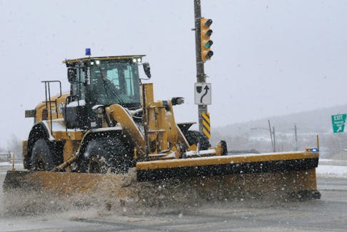 A City of St. John’s heavy equipment operator heads down along Columbus Drive approaching the Thorburn Road intersection on Wednesday, Feb. 8, while clearing the very busy thoroughfare from the falling snow and slush on the roadway. — Joe Gibbons/The Telegram