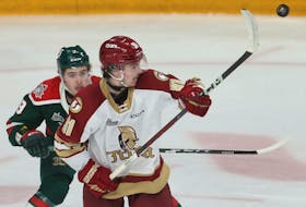 Acadie Bathurst Titan Colby Huggan tries to grab a flying puck in front of Halifax Mooseheads Adam Kilfoil during QMJHL action in Halifax Friday March 29, 2024.

TIM KROCHAK PHOTO