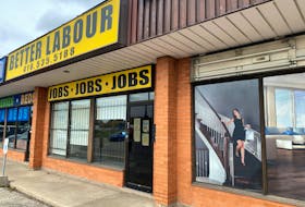 A view of an illustration outside a wood flooring sales office next to an employment agency in Toronto, Ontario, Canada October 8, 2021.