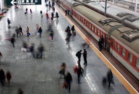 Passengers board a train at the Shanghai's railway station, January 19, 2012.