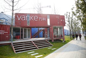 Sign of Vanke is seen outside of a construction site in Shanghai, China, March 21, 2017.