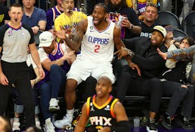 Apr 18, 2023; Phoenix, Arizona, USA; Los Angeles Clippers forward Kawhi Leonard (2) reacts as he falls out of bounds into the crowd next to former NFL player Terrell Suggs (right) against the Phoenix Suns in the second half during game two of the 2023 NBA playoffs at Footprint Center. Mandatory Credit: Mark J. Rebilas-USA TODAY Sports