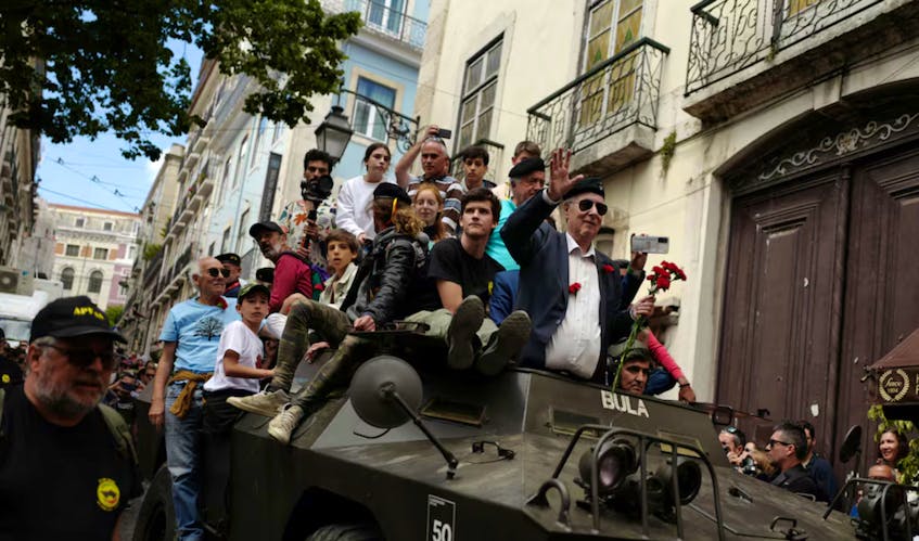 Retired members of the military stand inside an original military vehicle of Portugal's Carnation Revolution during the commemorations of the 50th anniversary of Portugal's Carnation Revolution that resulted in the overthrow of dictatorship. Pedro Nunes/Reuters