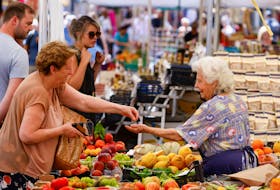 A woman shops at Campo de' Fiori market, on the day the European Central Bank's rate-setting Governing Council holds an unscheduled meeting to discuss the recent sell-off in government bond market, in Rome, Italy, June 15, 2022.