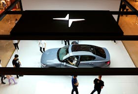 People look at a Polestar 2 electric sedan displayed in a shopping mall in Shanghai, China May 5, 2020. Picture taken May 5, 2020.