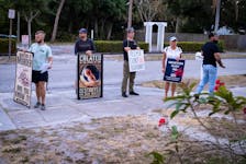Anti-abortion activists stand outside an abortion clinic in Fort Pierce, Florida, U.S., April 27, 2024.