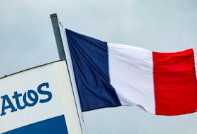 A French national flag flies near a logo of French IT consulting firm Atos, at the entrance of a company's building, in Angers, France, March 20, 2024.