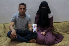 Zakaria Hamuda and his wife Sondos, parents of Palestinian infant Yehia, who was evacuated to south Gaza as a premature baby after Israeli forces raided Kamal Adwan hospital in northern Gaza Strip and is currently separated from his parents due to an Israeli checkpoint that separates north Gaza from the south, display a picture of him on a mobile phone, in Jabalia in the northern Gaza Strip, April 25, 2024.
