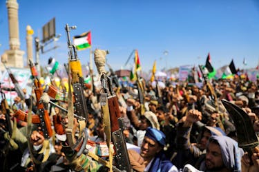 Protesters hold up rifles during a rally organized by the Houthis in support of Palestinians in the Gaza Strip, amid the ongoing conflict between Israel and the Palestinian Islamist group Hamas, in Sanaa, Yemen March 22, 2024.