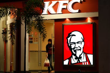 A customer leaves a KFC fast food restaurant in Dengkil, outside Kuala Lumpur November 3, 2012.