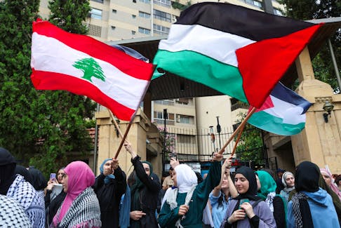 Demonstrators hold Lebanese and Palestinian flags during a protest in solidarity with Gaza at the Lebanese American University (LAU), in Beirut, Lebanon April 30, 2024.