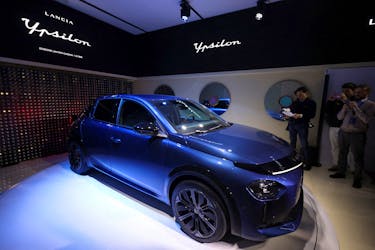 People look on during the unveiling of the new fully electric Lancia Ypsilon in Milan, Italy, February 14, 2024.