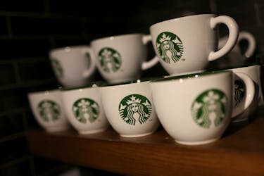Branded coffee mugs are displayed in Starbucks' outlet at a market in New Delhi, India, May 30, 2023.