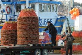 Crewmembers load crab pots onto a fishing boat at St. John's at the start of the 2022 fishing season. Joe Gibbons/Telegram File Photo