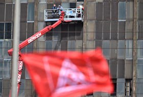 Steelworkers listen to the rally atop a boom lift at the Thyssenkrupp Steel Europe site during an IG Metall union protest in Duisburg, Germany April 30, 2024.