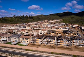 A drone view shows single-family homes at a new subdivision under construction in the rural hills of San Marcos, California, U.S., March 25, 2024. 