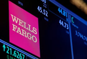The logo and trading information for Wells Fargo are displayed on a screen on the floor of the New York Stock Exchange (NYSE) in New York City, U.S., October 14, 2016. 
