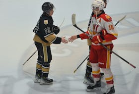 Charlottetown Islanders forward Matthew Butler, 13, shakes hands with Baie-Comeau Drakkar defenceman Émile Chouinard, 15. Baie-Comeau defeated the Islanders 7-1 at Eastlink Centre on April 3 to win the best-of-seven opening-round playoff series in the Quebec Maritimes Junior Hockey League 4-0. Jason Simmonds • The Guardian