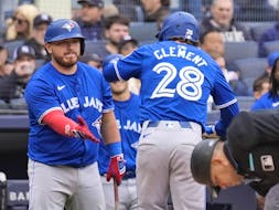 Toronto Blue Jays' Alejandro Kirk, left, greets Ernie Clement (28) after Clement hit a home run against the New York Yankees.
